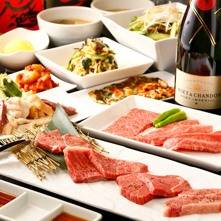 A table set with assorted yakiniku and wine