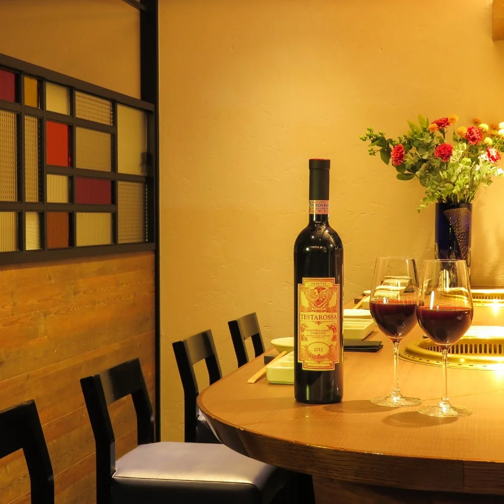 Semi-private dining room with tables beneath soft lighting